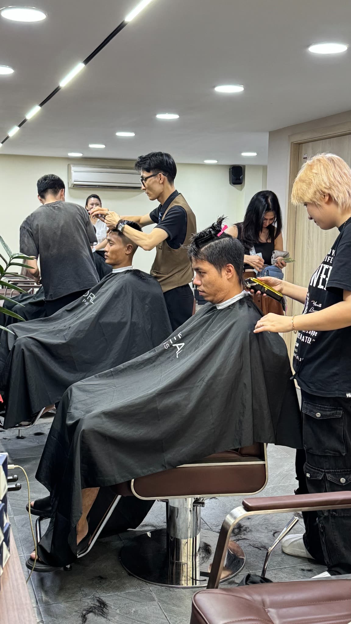 Men receiving haircuts at Mr. Relax in Da Nang